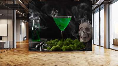 Halloween green cocktails with skulls, spiders and smoke on black background. Horror funny food . Wall mural