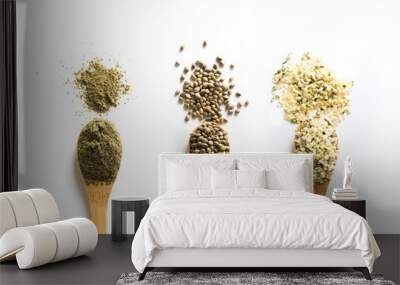 Organic dried hemp seeds, flour, kernels in wooden spoon on white background. View from above. Wall mural