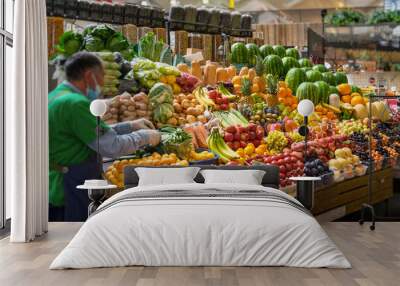 Assortment of fresh organic vegetables and fruits at the farmers market, abstract salesman, farmer. Autumn harvest Wall mural