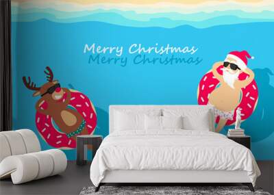 Christmas holiday. Santa Claus and deer relaxing on inflatable donuts. Greeting Christmas card 2020 Wall mural