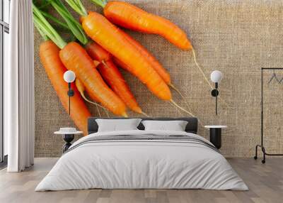 Fresh organic carrots on burlap background. Copy space Wall mural