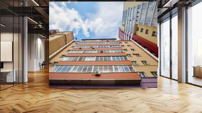 Architecture raising to the sky. Up to the sky view. View at the house from the bottom up Wall mural