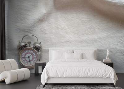 Clock alarm clock on a white cloth background of the table Wall mural