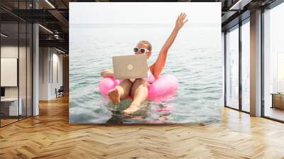 Freelance close up woman hands writing on computer. Well looking middle aged woman typing on laptop keyboard outdoors with beautiful sea view. Wall mural