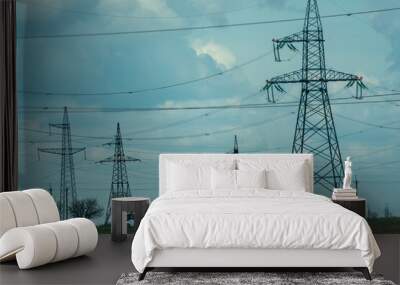 High voltage towers with sky background. Power line support with wires for electricity transmission. High voltage grid tower with wire cable at distribution station. Energy industry, energy saving Wall mural