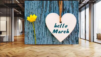 Hello March greeting card with decorative white heart and yellow spring flower on old blue wooden background.Springtime concept. Wall mural