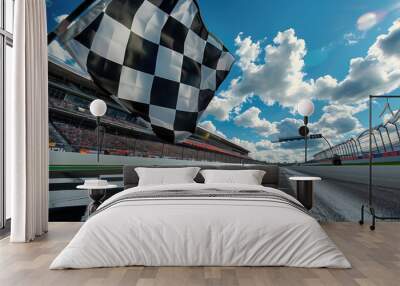 A checkered flag is flying in the air above a race track Wall mural