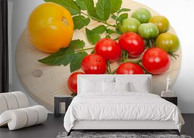 Branch of fresh tomatoes with on a round wooden board isolated o Wall mural