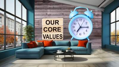 Conceptual words Our Core Values on wooden blocks on wooden background with clock. Business value and our concept of core values. Copy space. Wall mural