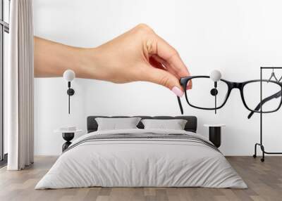 Hand with black eyeglasses, eye optic correction tool. Wall mural