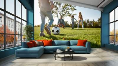 Are You Ready for Some Football. Happy family playing with a ball on meadow Wall mural