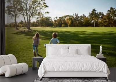 Children are our most valuable natural resource. Two kids playing with a ball on meadow Wall mural