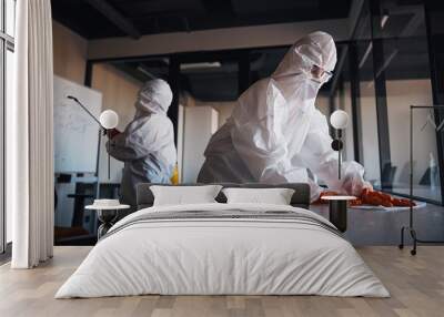 Cleaning staff in protective gear disinfecting the office workplaces Wall mural