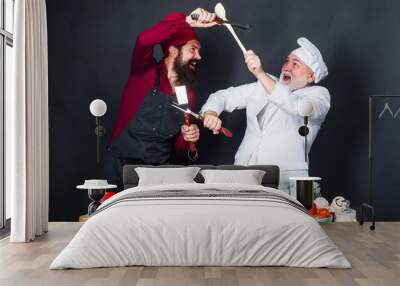 Culinary battle of professional chef. Two chefs in uniform on kitchen compete in culinary show. Kitchen rules. Cooking challenge. Two cook or baker fighting with kitchen utensils. Competition of chef. Wall mural