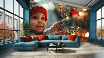 Happy baby decorates a Christmas tree with string lights Wall mural