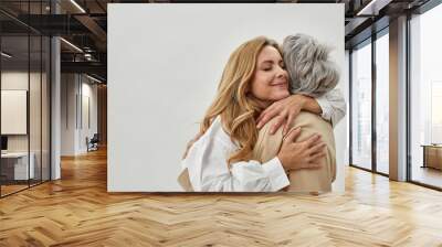 Loving adult daughter embrace old mother feel grateful Wall mural