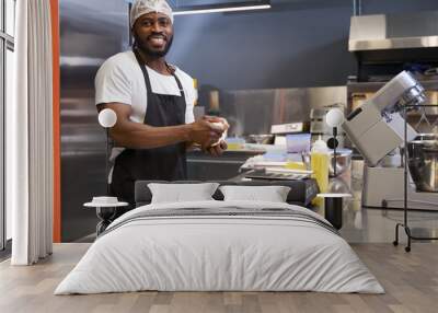 Man working at the kitchen and looking at the camera Wall mural