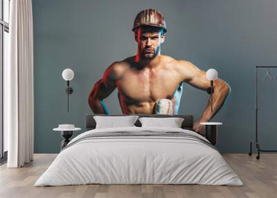 Professional painter with paint roller. Muscular man with paintroller. Builder in hardhat with painting roller. Room painting job. Decorator, painter with painting roller. Home renovation, redecorate. Wall mural