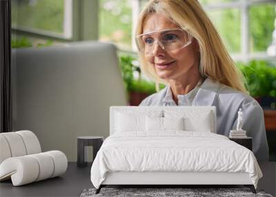 Scientist sitting in front of her computer Wall mural