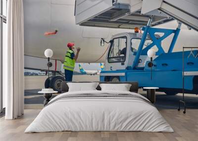 Two airdrome workers installing the aircraft steps Wall mural