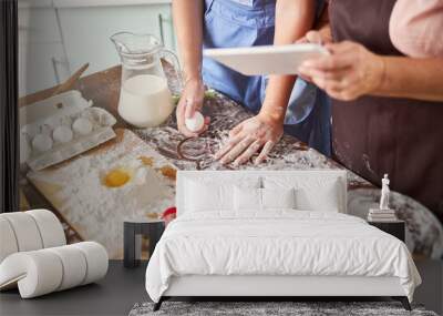 Two busy cooks preparing to make dough in kitchen Wall mural