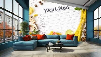 A meal plan for a week on a white table among products for cooking - pastas, basil, vegetables, lime, seeds, nuts and spices. Top view, flat lay, copyspace Wall mural