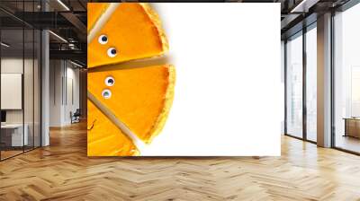 Slices of pumpkin pie in form of Halloween ghost with eyes on white isolated background with copy space. Festive creative food concept Wall mural