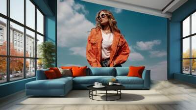 High fashion portrait of stylish beautiful woman in trendy jackets and jeans posing outdoor. Vogue style. Wall mural