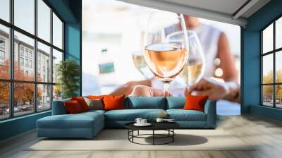 Four female friends drinking wine in street cafe Wall mural