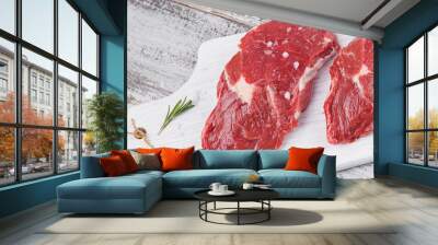 Raw fresh beef steak on a white cutting board Wall mural