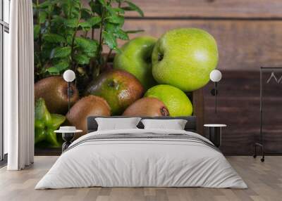 Set of green fruits for healthy diet and detox: apple, lime, kiwi, mango, carambola and mint. Wall mural