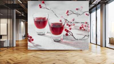 Two glasses of cherry liqueur on white background. Christmas or new year party celebration concept. Winter holidays concept. Wall mural