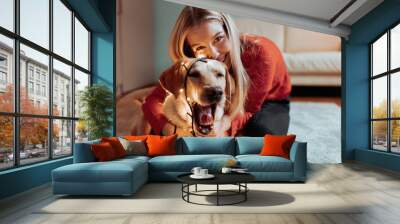 Christmas gifts and happiness between a young couple and a cute dog Wall mural