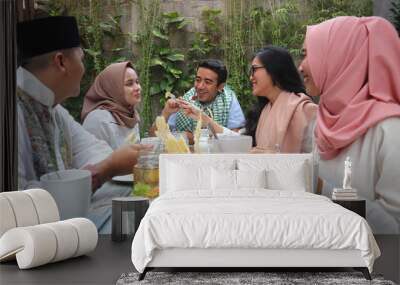 group of happy young muslim having dinner outdoor during ramadan celebration Wall mural