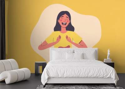 A woman with a joyful expression stands in front of a yellow background, wearing a yellow shirt with an image of the intestines on it, symbolizing gut health. Wall mural