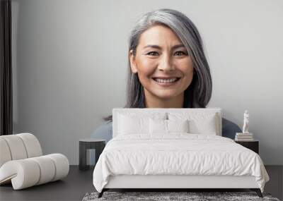 Beautiful asian with grey hair smiling standing near the wall Wall mural