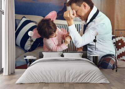 Daughter helping button father shirt. Father is dressing up for work. Having business meeting. Wall mural