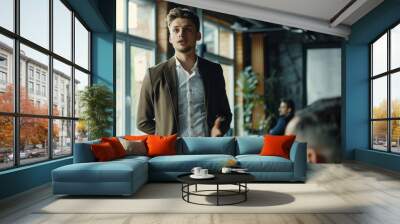 A young, energetic male entrepreneur presenting his innovative idea to a group of investors. He’s in a sleek, modern co-working space, with a presentation on a large screen. Wall mural