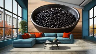  A bowl of black beans on a wooden table Wall mural