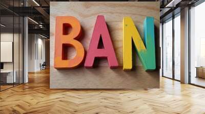  Colorful wooden letters spelling BAN on a wooden surface Wall mural