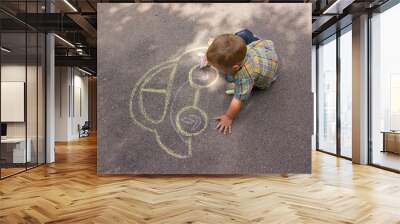 Boy drawing with chalk on the asphalt Wall mural