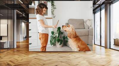 Cute little girl with dog at home Wall mural