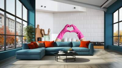 Heart made of pink protective gloves on white kitchen background.. Woman hands wearing protective gloves. Concept of clean kitchen, successful thumb up yes ok sign Wall mural