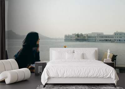 girl looks at Taj Lake Palace at Udaipur, India Wall mural