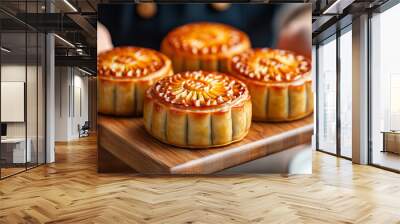 Hands of people eating tasty round moon cakes at mid autumn festival, Moon cake Mooncake table setting - Round shaped Chinese traditional pastry with tea cups on wooden background, Mid-Autumn Festival Wall mural