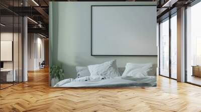 Stylish bedroom with comfortable bedding, light green walls, and a large empty frame for artwork. Perfect for interior design inspiration. Wall mural