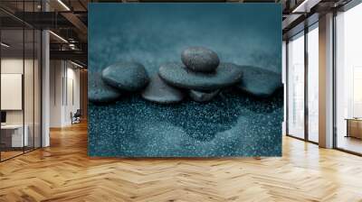 Black spa stones on the gray table background. Wall mural