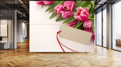 Mother's Day card and a bouquet of beautiful tulips on wooden background. Wall mural