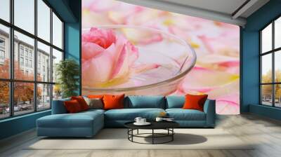 pink rose in a bowl of water and petals. Wall mural