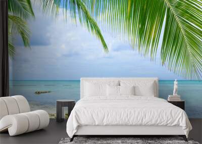 Travel background with Caribbean sea and palm leaves . Wall mural